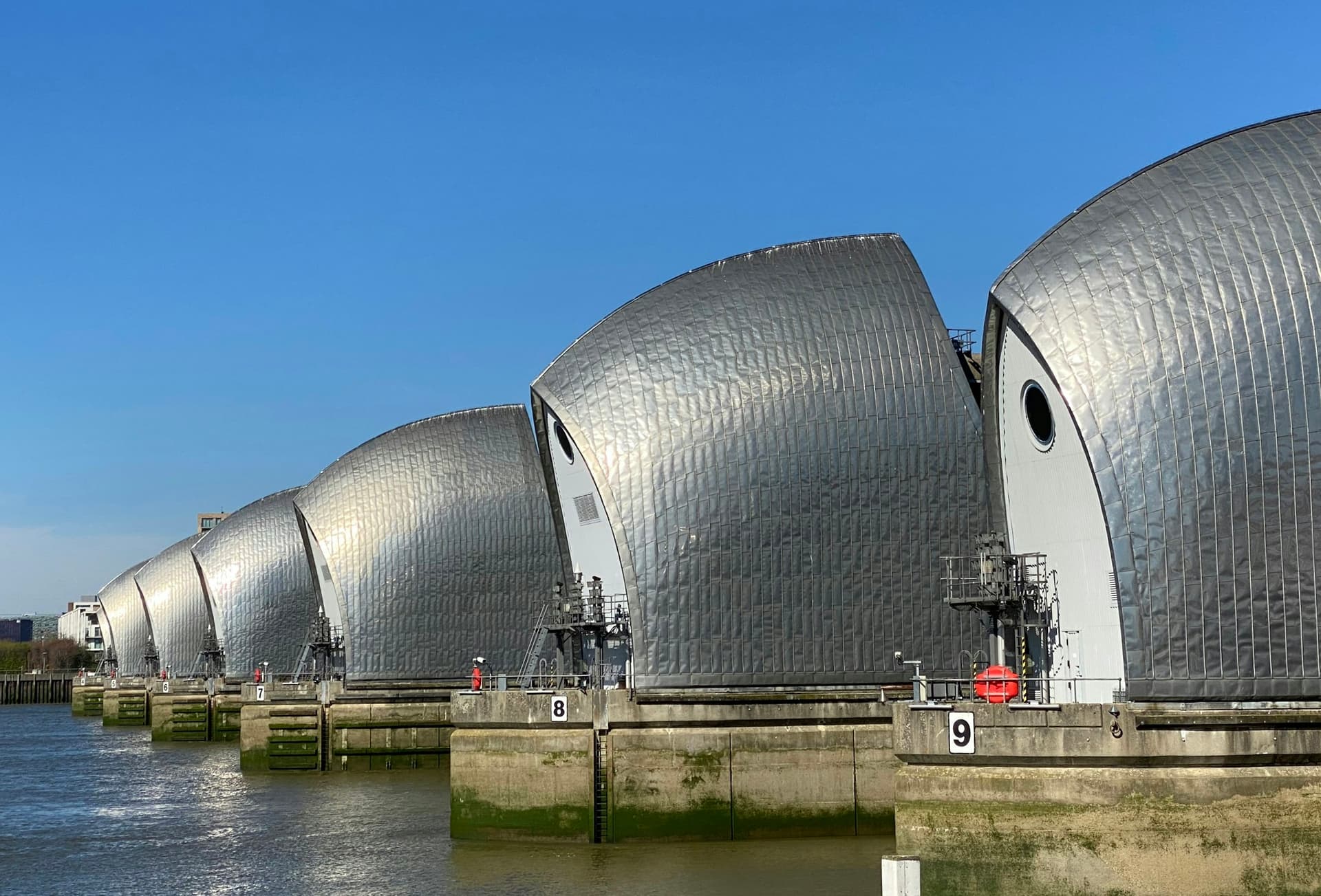 The steel gates of the Thames Barrier, London, in clear light.